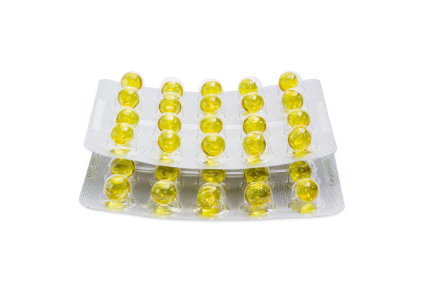 Набор волдырей с желтыми таблетками на светлом фоне
 - Фото, изображение