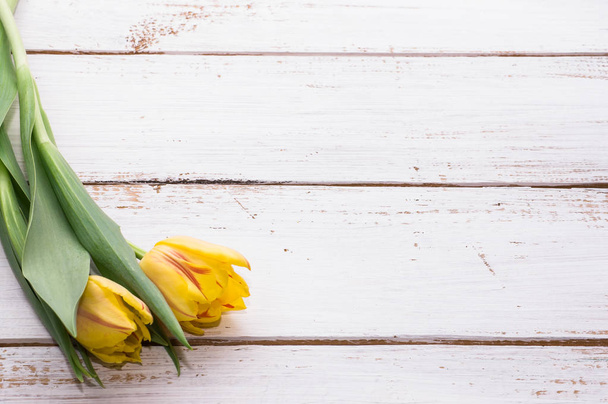 Yellow tulips on wooden background, mother's day card - Fotografie, Obrázek
