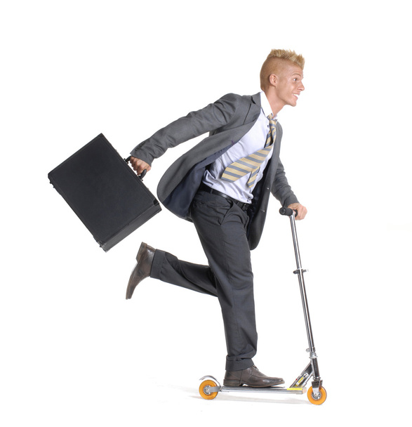Young businessman skating on white background. - Foto, afbeelding