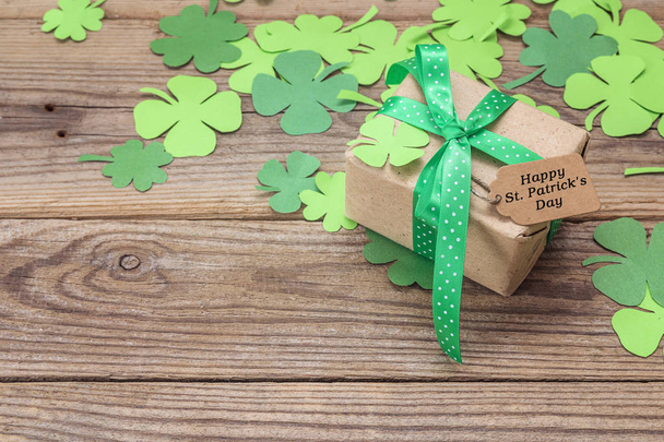 St. Patrick's Day background with gift box and clover leaves on  - Фото, зображення