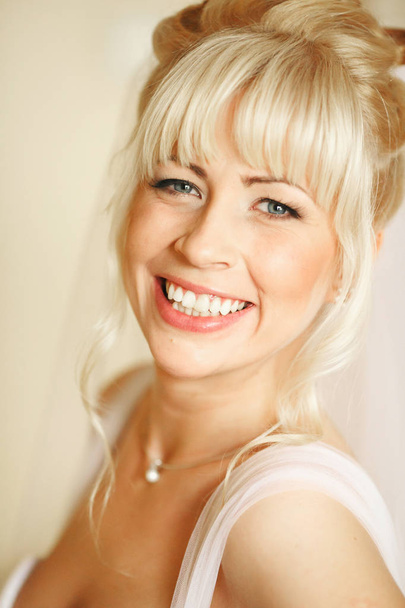 Fabulous bride with blonde hair smiles  - Fotografie, Obrázek