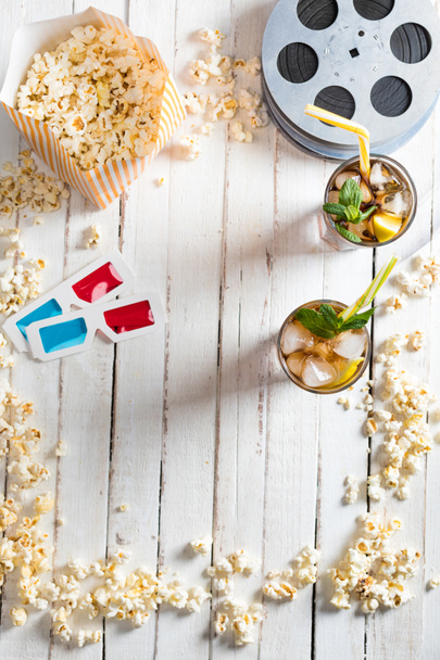 Popcorn with iced tea and film reels    - Фото, зображення