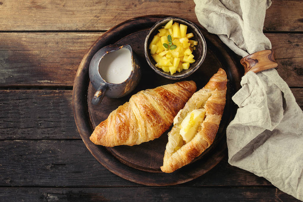 Breakfast with croissant and mango fruit - Foto, Imagen