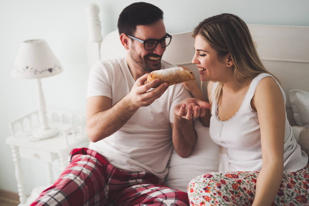 Couple eats breakfast in bed  - Фото, зображення