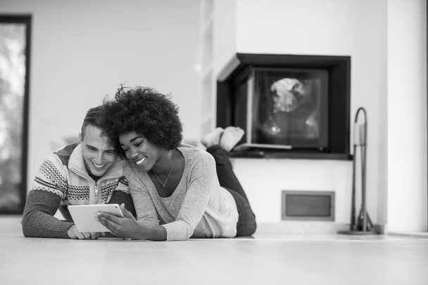 multiethnic couple used tablet computer on the floor - Valokuva, kuva