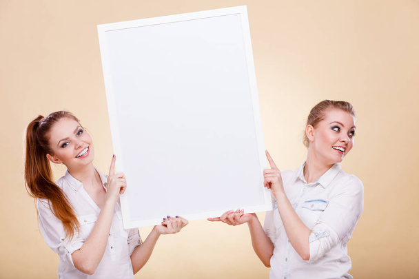 Two girls with blank presentation board - Foto, Imagen