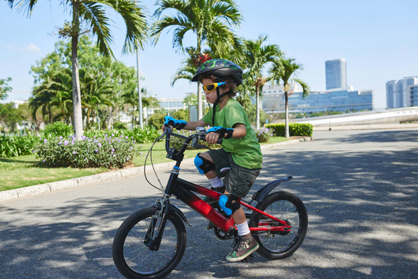 boy in sunglasses riding bicycle - Photo, Image