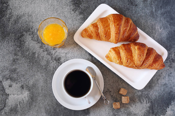 Two fresh croissants, orange juice and cup of coffee for breakfa - Photo, Image