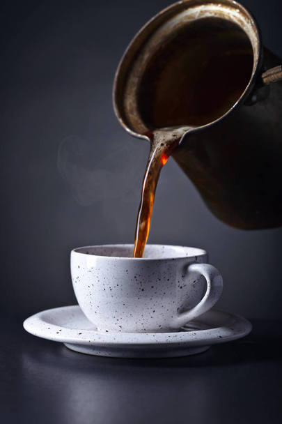 Cup of black coffee on dark background - 写真・画像