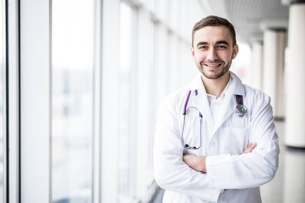 Portrait of attractive young doctor in clinic hall - Photo, Image