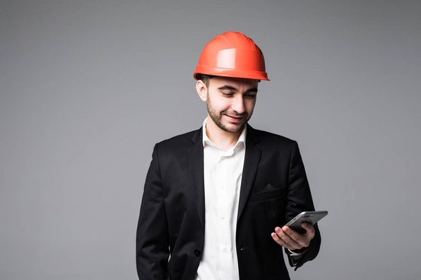 Man engineer using mobile phone on white background - Foto, Imagen