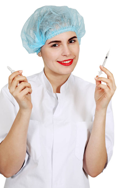 Медсестра тримає флакон і шприц
 - Фото, зображення