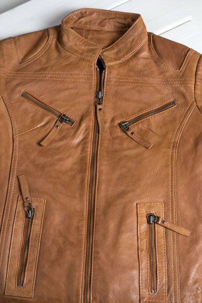 Light brown leather jacket. Beige color leather jacket on hanger.  - Фото, зображення