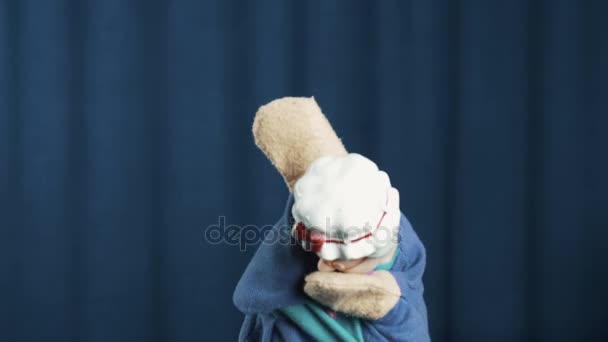 Grandmother hand puppet shake head and fooling around on blue background - Footage, Video