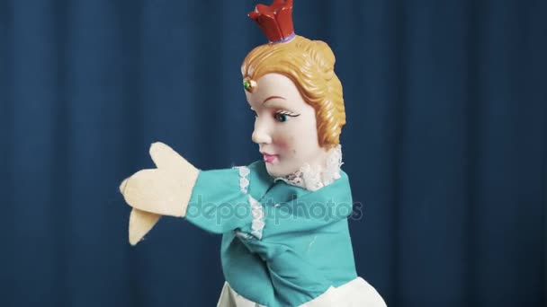 Princess hand puppet rubbing and shaking arms , waving on blue background - Footage, Video