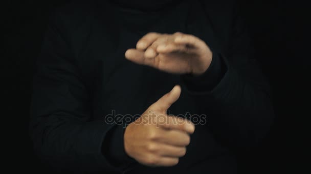 Male hand in long sleeve jacket finger gesture mimicking pistol gun shooting - Footage, Video