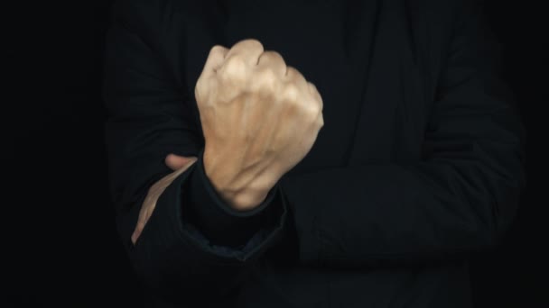 Hosszú ujjú kabát húzza fel, hogy obszcén-bejelentkezési gesztus ököl férfi kezét - Felvétel, videó