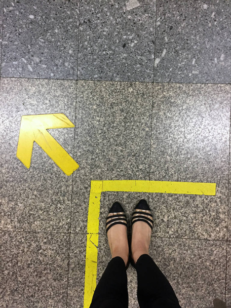 Nainen jalat mustat kengät ja nuoli menossa eteenpäin
  - Valokuva, kuva