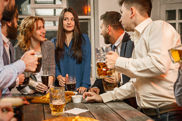 Group of friends enjoying evening drinks with beer - Fotografie, Obrázek