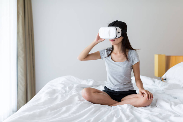 Mujer mirando a través del dispositivo de realidad virtual
  - Foto, imagen