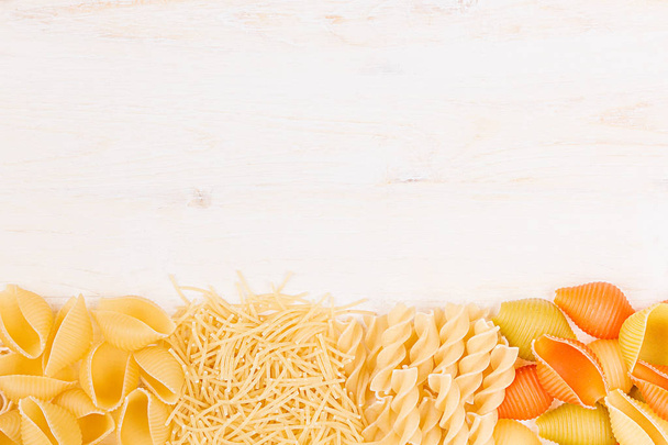 Pasta background decorative border of assortment different kinds italian macaroni.  - Foto, afbeelding
