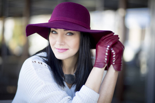 elegant young woman with beautiful make-up in a the burgundy hat - Photo, Image