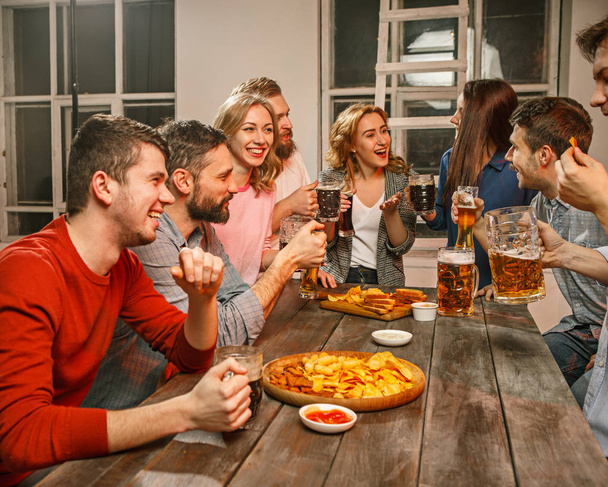 Group of friends enjoying evening drinks with beer - Foto, immagini