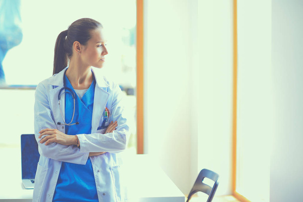 Woman doctor standing near window at hospital - Photo, image