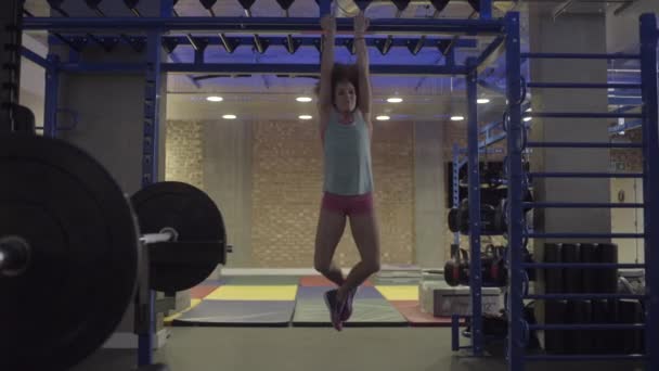 Young woman doing monkey bar exercises  - Video