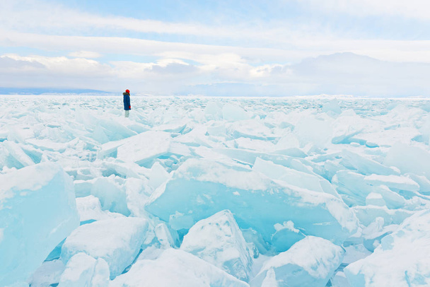Viajante olha para um campo de gelo que cobre o lago Baikal no inverno
. - Foto, Imagem
