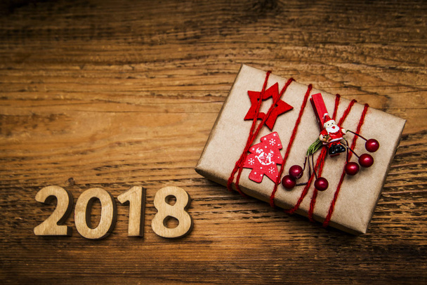 box and red ribbon  on wooden background.  - Φωτογραφία, εικόνα