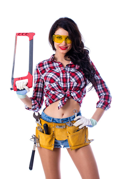 Sexy brunette woman mechanic with a wrench - Foto, afbeelding