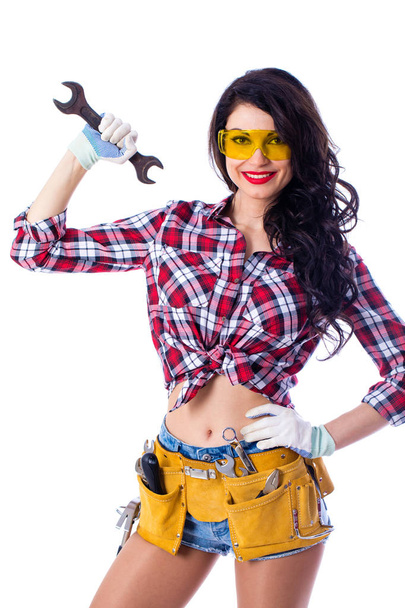 Sexy brunette woman mechanic with a wrench - Fotó, kép
