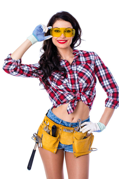 Sexy brunette woman mechanic with yellow safety glasses - Foto, immagini