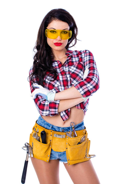Sexy brunette woman mechanic with yellow safety glasses - Foto, imagen