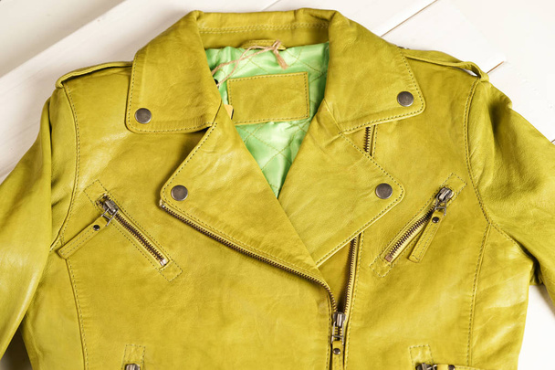 Green color leather jacket. Leather jacket macro details. Jacket zippers and pockets.  - Foto, Imagem