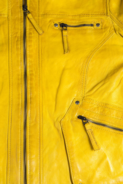 Yellow leather jacket zipper. Macro leather jacket details - Zdjęcie, obraz