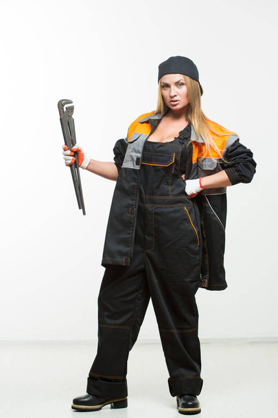 Nice sexy woman mechanic holding wrench isolated over white background - Fotoğraf, Görsel