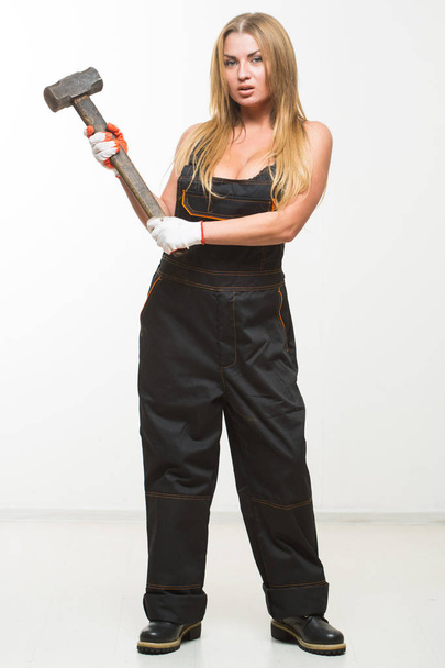 Nice sexy woman mechanic holding wrench isolated over white background - Photo, Image