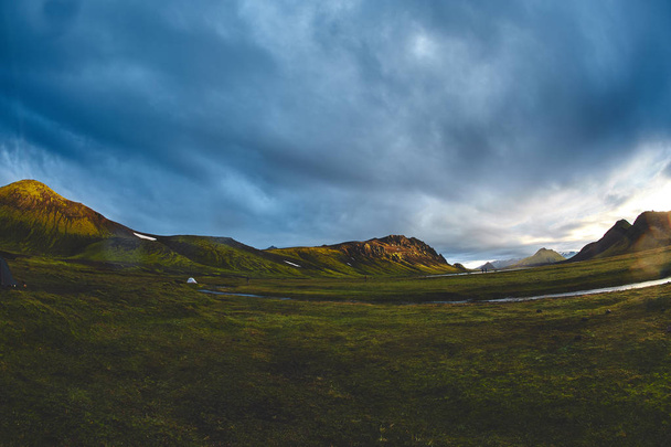 trekking in Iceland. camping with tents near mountain lake - Foto, afbeelding
