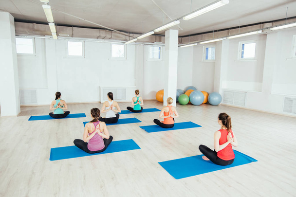 women making yoga meditation in lotus pose .fitness, sport, people and healthy lifestyle concept - Φωτογραφία, εικόνα