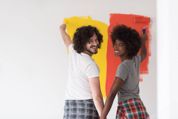 couple painting interior wall - Photo, image