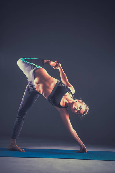 Portrait of sport girl doing yoga stretching exercise - Foto, afbeelding
