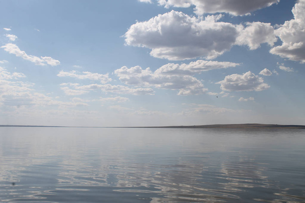 the sky reflected in the water, deserted beach lake, summer sky, nature, blue cloud, - Valokuva, kuva