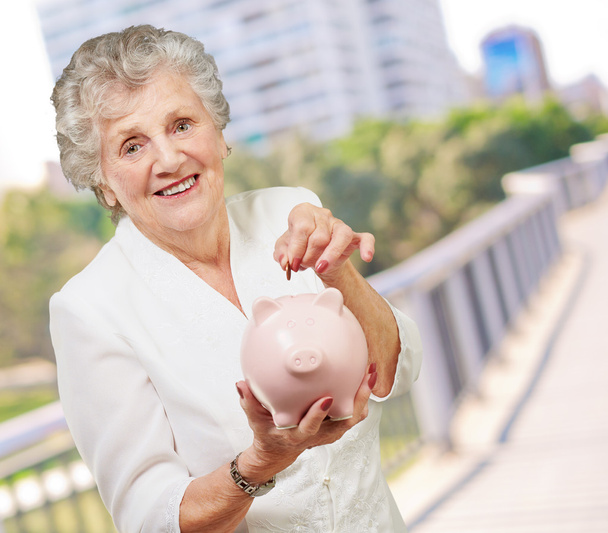 Portrait Of A Mature Woman With A Piggy Bank - Photo, Image