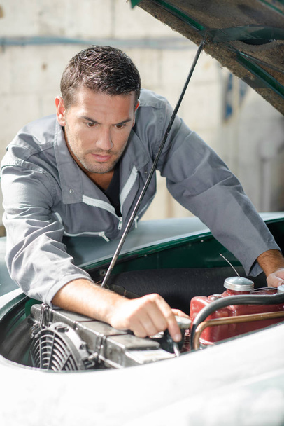 Man trying to fix his car - Photo, image