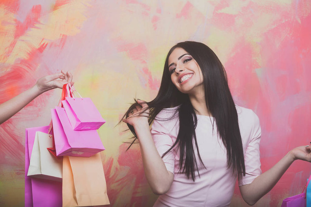 pretty sexy smiling woman with shopping bags on colorful background - Foto, Imagen