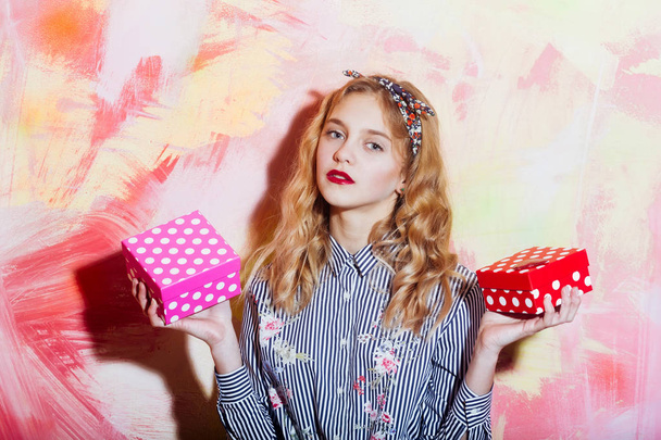 Pretty girl with two red and pink polkadot gift boxes - Valokuva, kuva