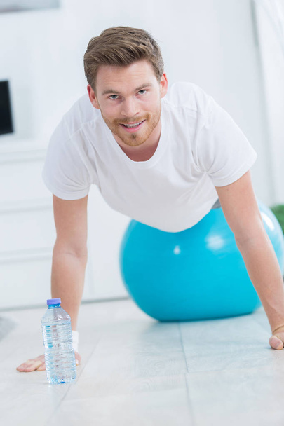 sporty man doing push ups exercises on the gym ball - Foto, Imagen