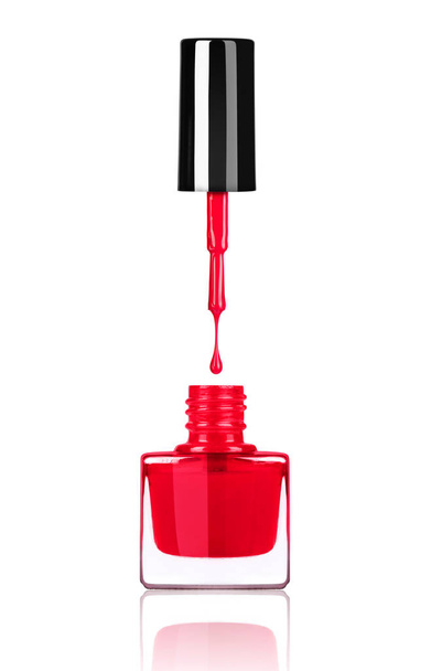 Nail polish dripping from brush into bottle on white background - Foto, imagen